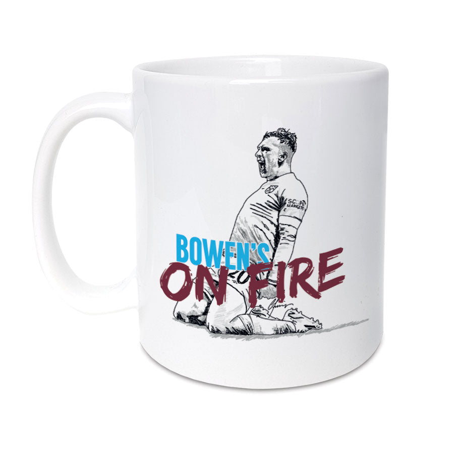 West Ham United FC themed 11oz mug by Local Lingo - High-quality ceramic mug featuring an illustration of Jarrod Bowen celebrating with the wording "Bowen's on Fire." The mug showcases the team's victory in the Europa Conference League Final and is a must-have for passionate Hammers fans.