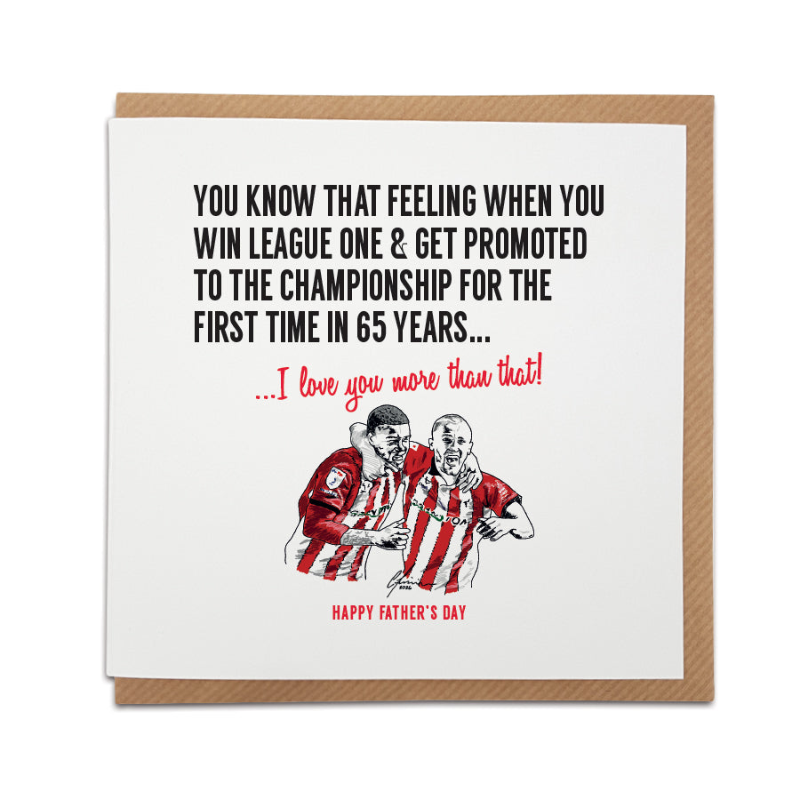 Square Father's Day greeting card resting on a brown kraft envelope. Bold black text reads: "You know that feeling when you win League One & get promoted to the Championship for the first time in 65 years...". Below it, red script reads "...I love you more than that!". A second line of red text at the bottom reads "HAPPY FATHER'S DAY". Features a hand-drawn illustration of Lincoln City players Ryan One and Tom Hamer celebrating in red and white striped kits. Sentimental Lincoln City Father's Day football fa