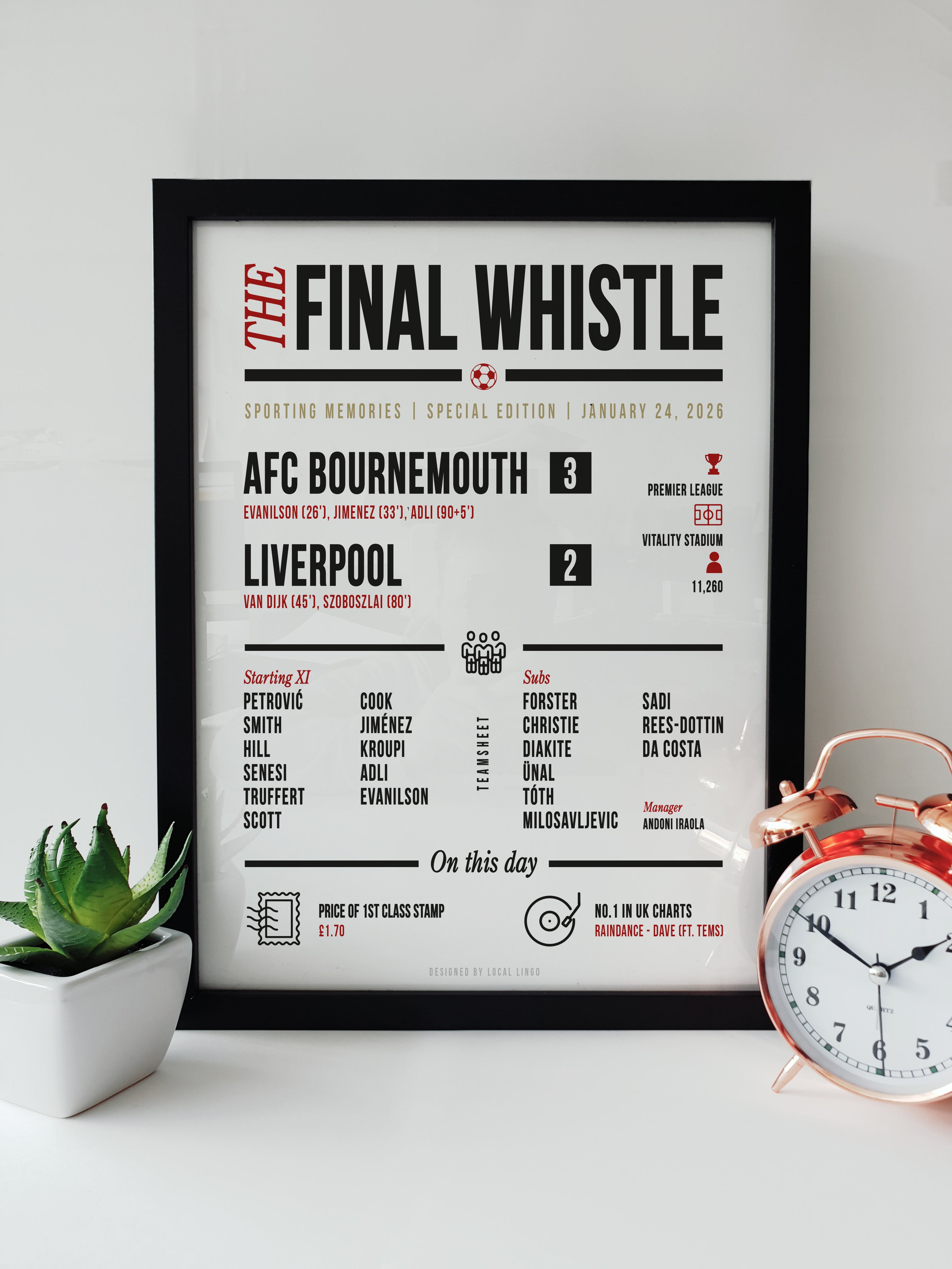 Framed typographic football print titled "The Final Whistle" showing stats for AFC Bournemouth 3 - 2 Liverpool, featuring goal scorers Evanilson, Jimenez, and Adli, displayed on a white wall next to a copper alarm clock.