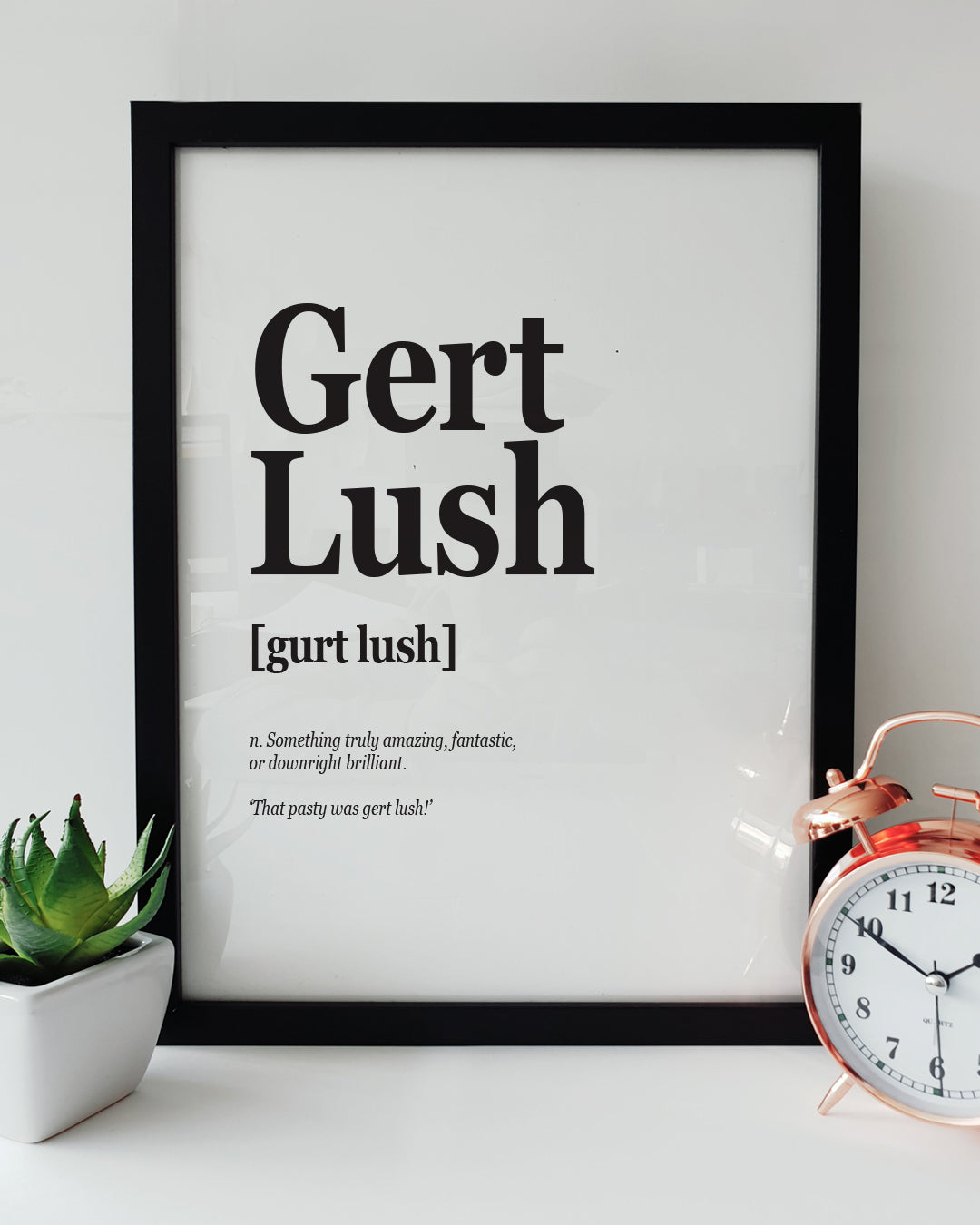 A minimalist wall art print featuring the Plymouth dialect phrase "Gert Lush" with its definition, designed by Local Lingo. The perfect gift or decor item for fans of regional sayings.