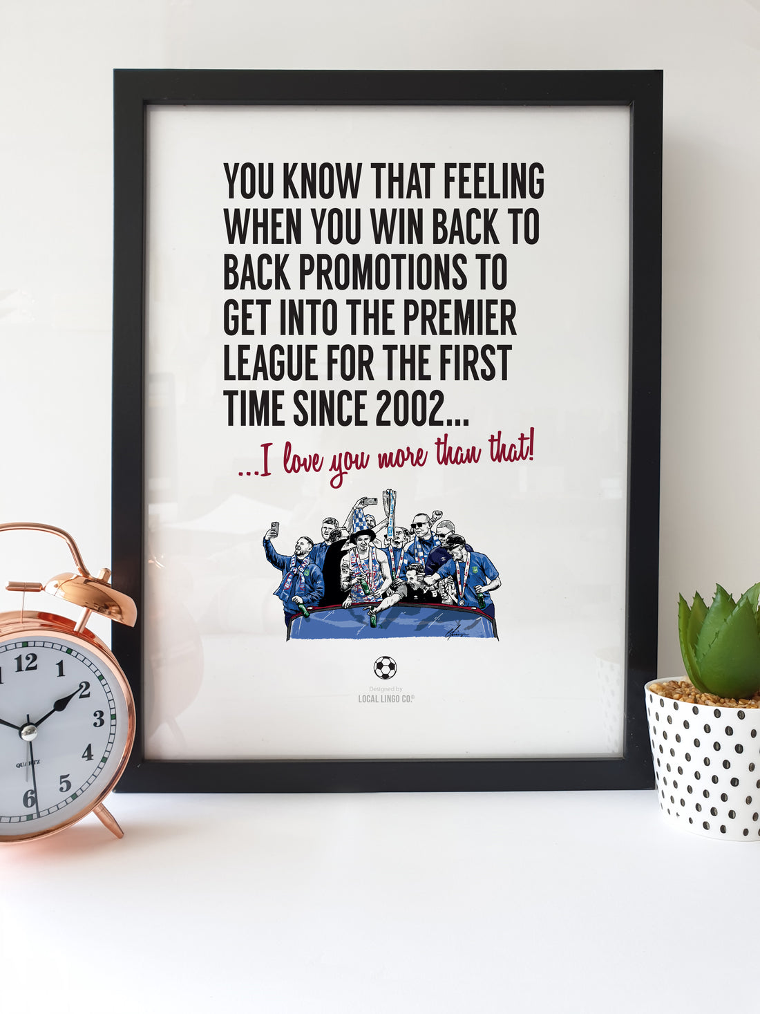 Framed print of Ipswich Town football team celebrating back-to-back promotions to the Premier League, with text expressing love greater than their triumph, designed by Local Lingo.