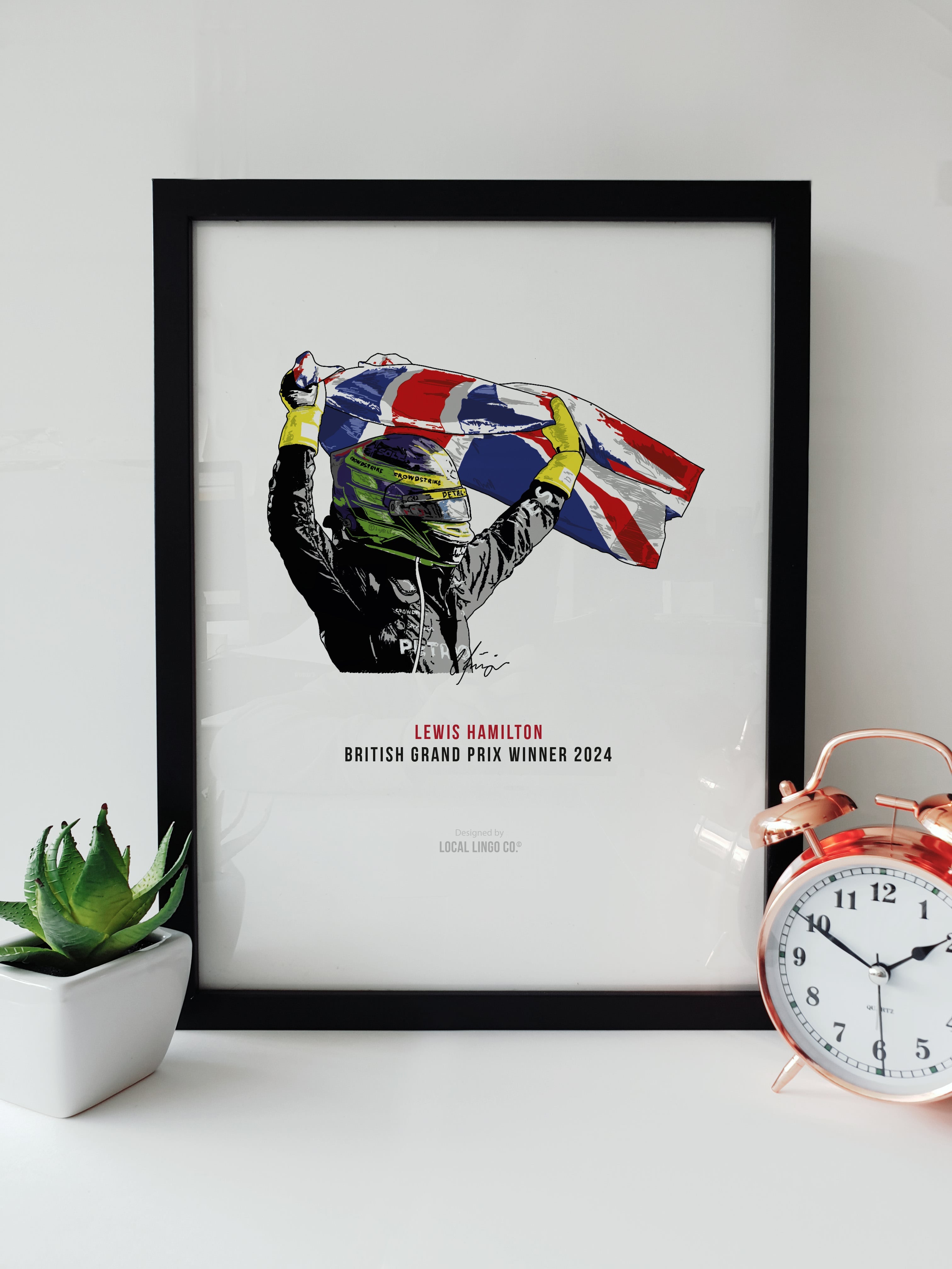 Lewis Hamilton British Grand Prix Winner 2024 Formula 1 Fan Artwork by Local Lingo, featuring an illustration of Hamilton celebrating with the Union Jack in a black frame.