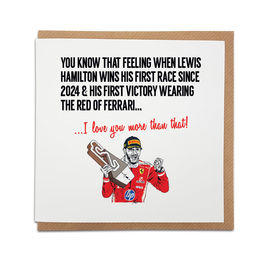 Square romantic greeting card resting on a brown kraft envelope. Bold black text reads "YOU KNOW THAT FEELING WHEN LEWIS HAMILTON WINS HIS FIRST RACE SINCE 2024 & HIS FIRST VICTORY WEARING THE RED OF FERRARI..." followed by red text reading "...I love you more than that!". Below is a hand-drawn illustration of F1 driver Lewis Hamilton celebrating with a trophy in his red Ferrari race suit. Lewis Hamilton Formula 1 anniversary card designed by Local Lingo.