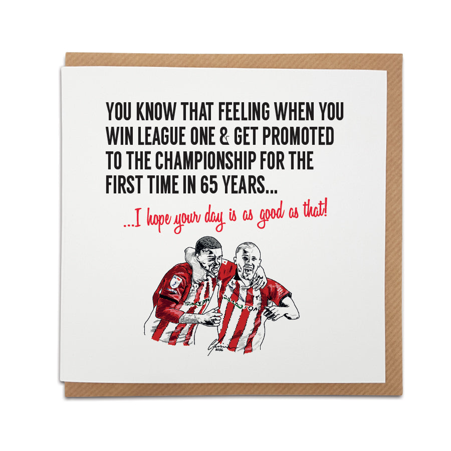 Square greeting card resting on a brown kraft envelope. Bold black text reads: "You know that feeling when you win League One & get promoted to the Championship for the first time in 65 years...". Below it, red script reads "...I hope your day is as good as that!". Features a hand-drawn illustration of two football players celebrating in red and white striped kits. Sentimental Lincoln City football fan card, designed by Local Lingo.