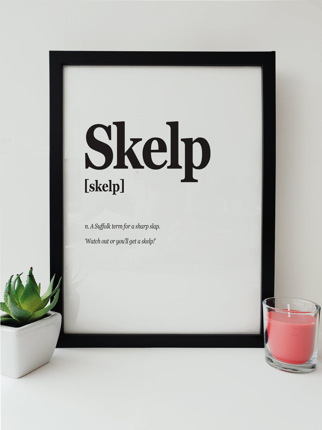 Modern black and white print displaying the word 'Skelp' from Suffolk dialect, meaning a sharp slap, alongside the humorous warning 'Watch out or you’ll get a skelp!' in an elegant font designed by local lingo