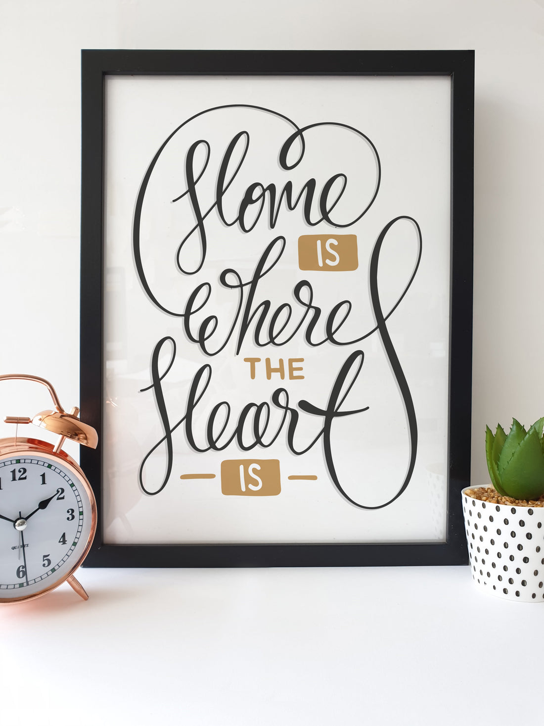 An unique Home themed print which features a handwriting style message. Perfect to display in your home.   Print Reads: Home is Where the Heart is